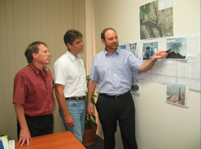 Left to right Bruce Knox, Craig Pocock and Ken Chapman looking over Skyrail plans on the wall