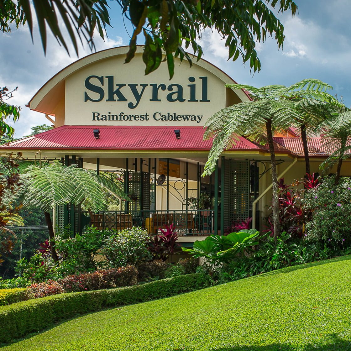 Terminal building and lush gardens in Kuranda village