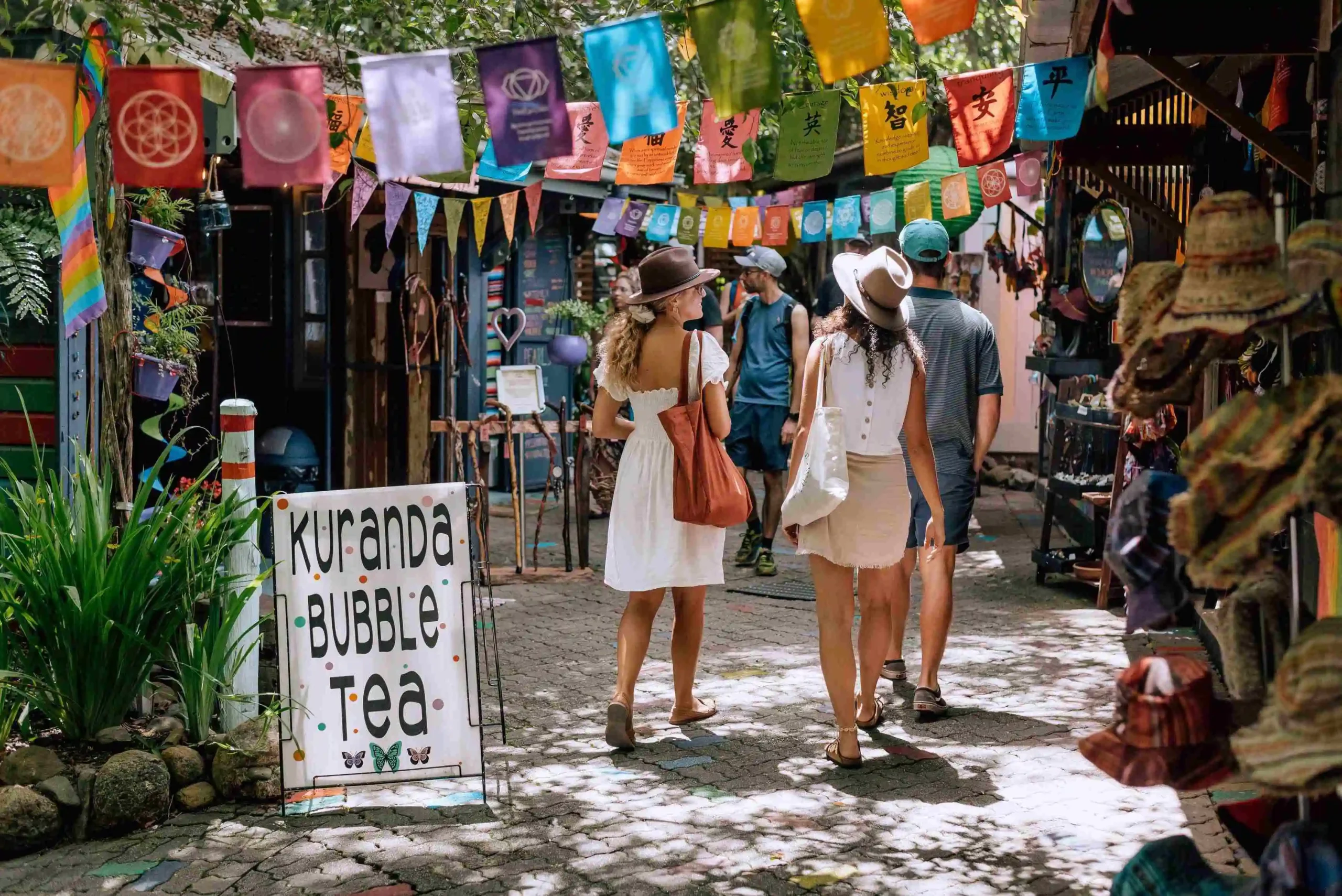 Two women walking through Kuranda-Original-Markets