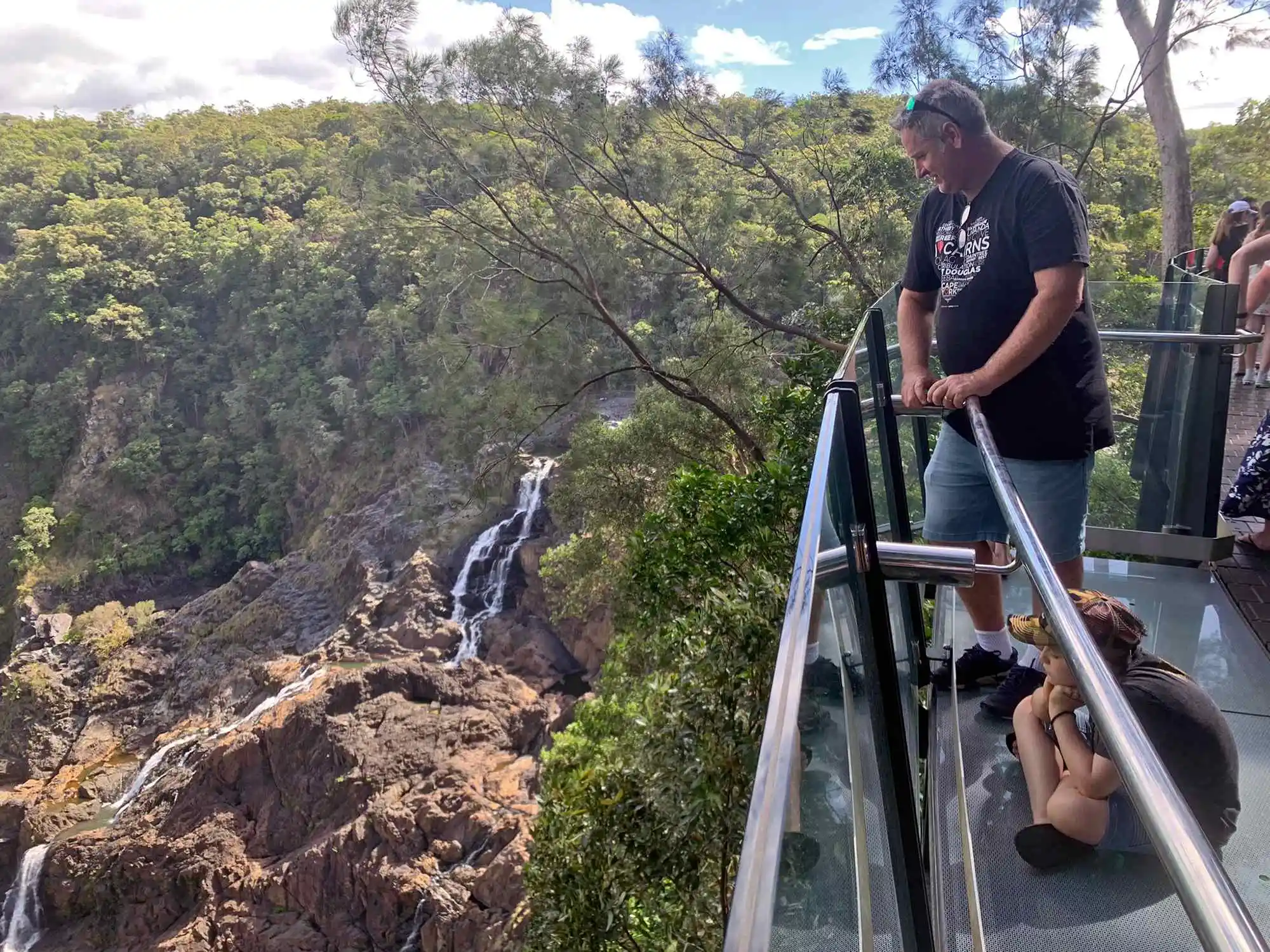 A man looking over The Edge Lookout at the Barron Falls.