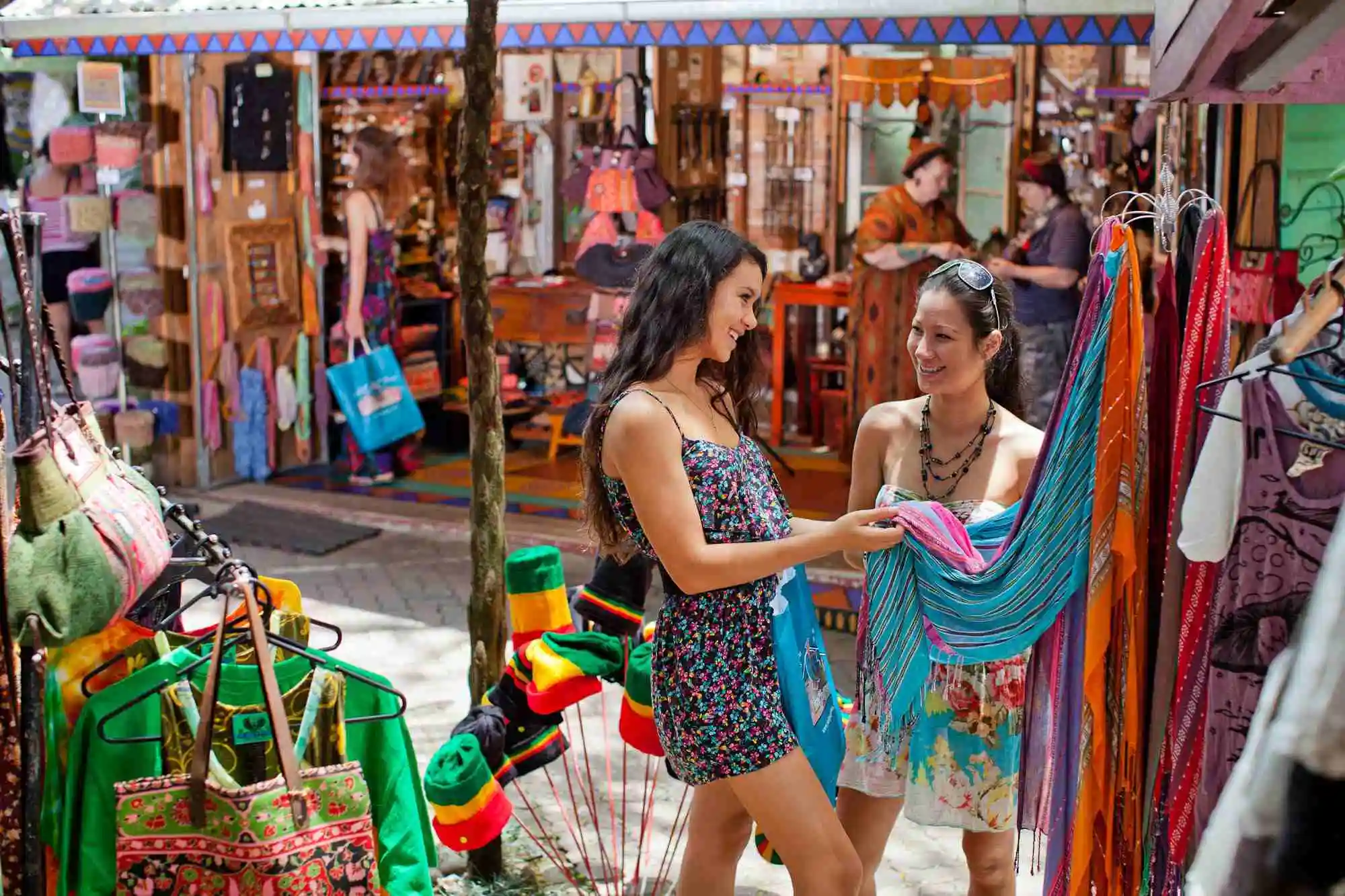 Two girls shopping in the colourful wooden Original Markets, Kuranda.