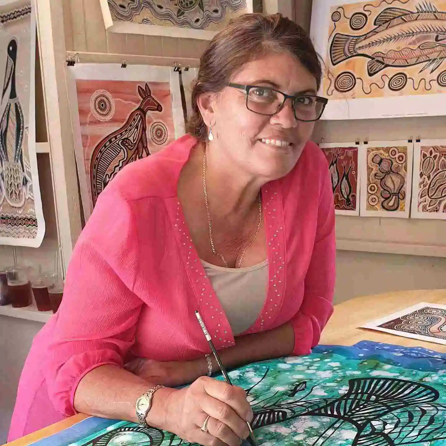 Artist Connie Rovina painting in her studio