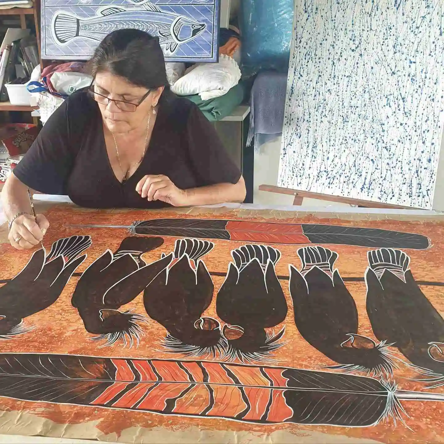 Artist Connie painting in her studio