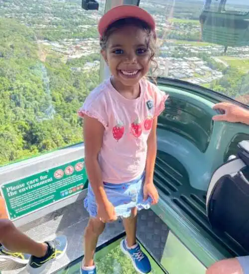 Tropical Mama and family enjoying Skyrail's Diamond View glass floor gondola