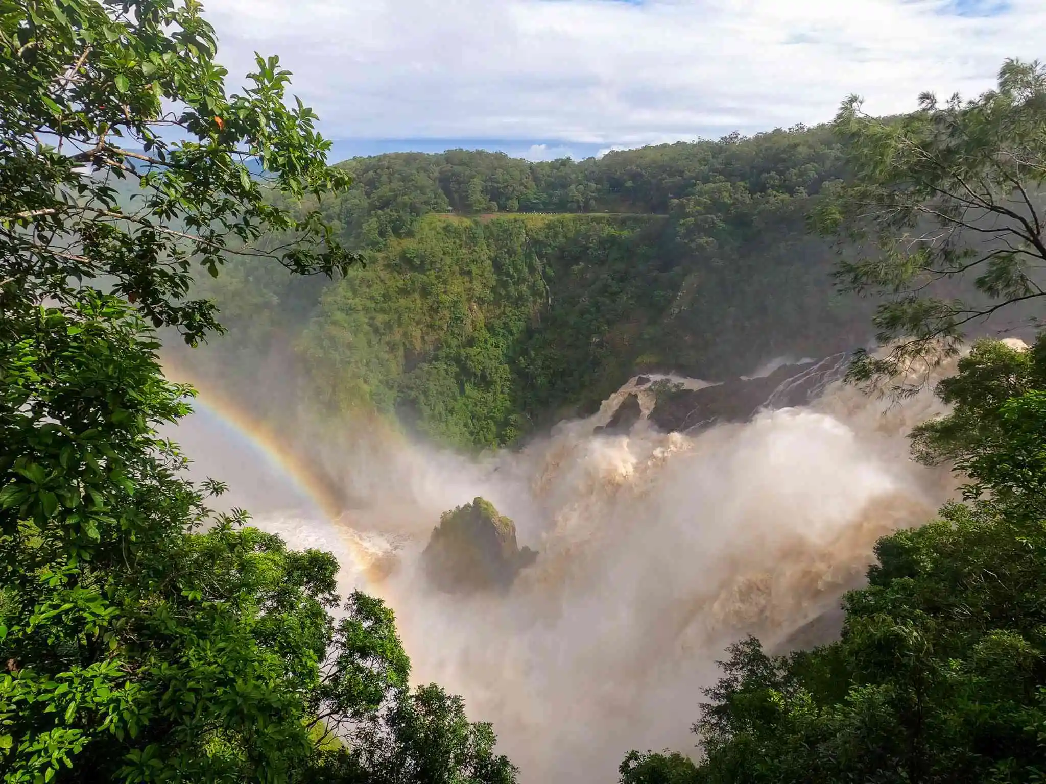 Impressive rainbow formations in a shroud of mist as the Barron Falls flows into the deep gorge.