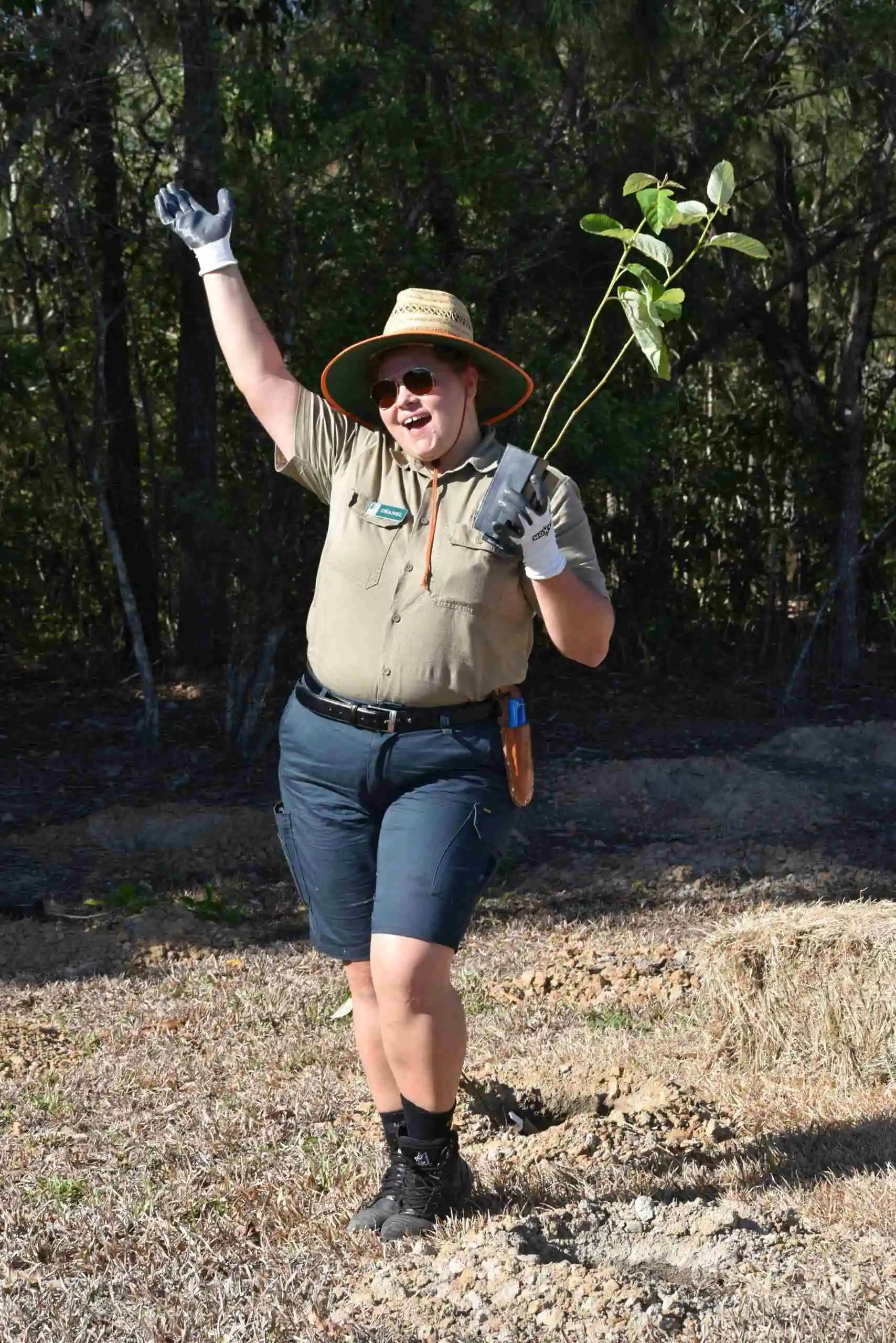 Skyrail Rainforest Ranger Chanel with a tree before planting at Tropical Tree Day to support a greener future in our community
