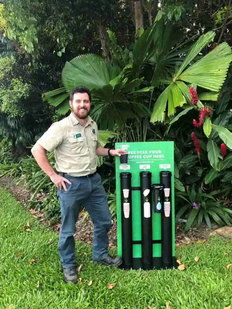 Ranger Tim placing a coffee cup in the simply cups recycling station