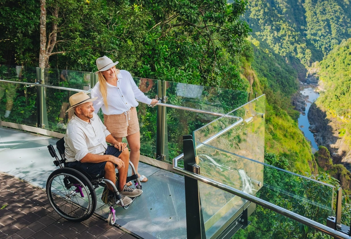 women stands next to a man in a wheelchair at Skyrails edge lookout